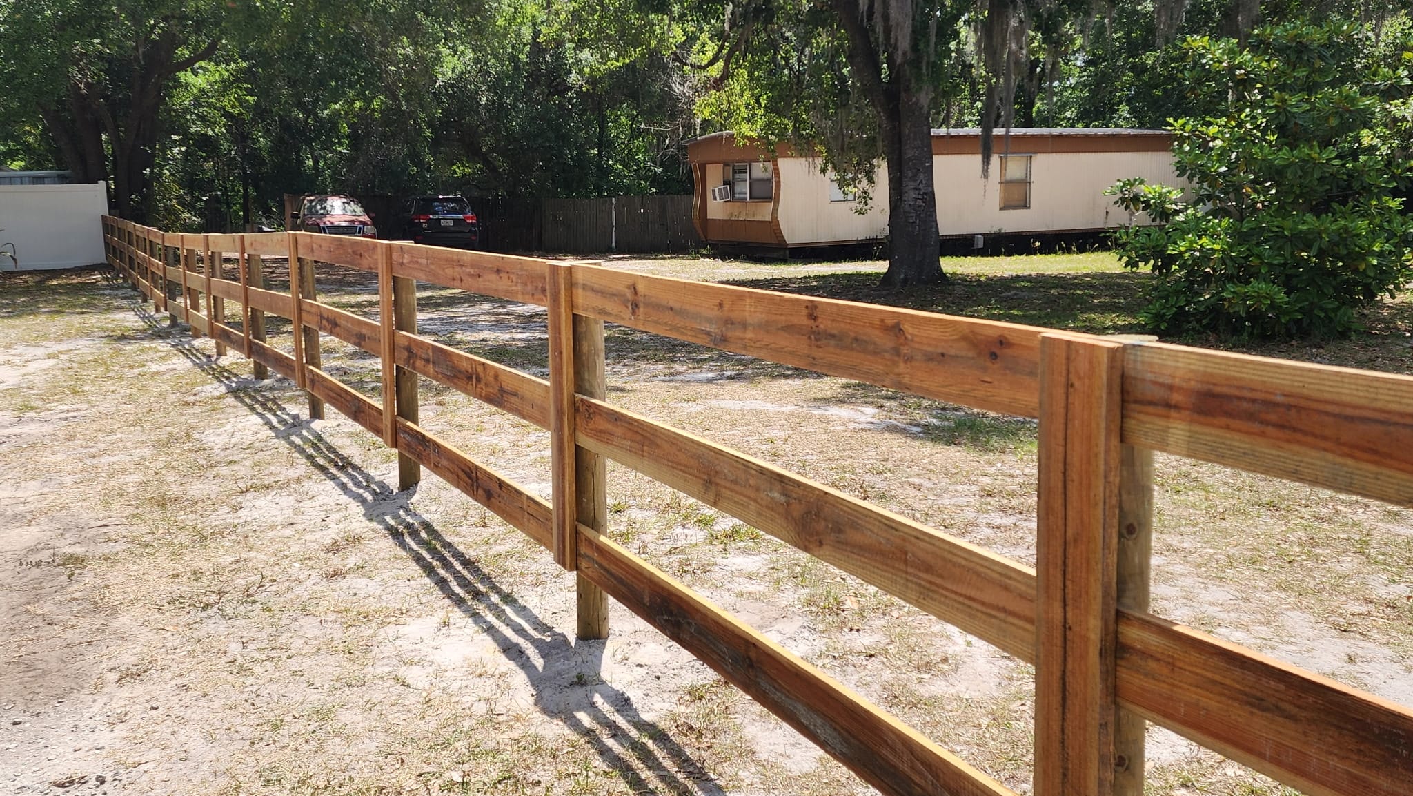 Four-board wood rail fence built by Wilson's Fencing